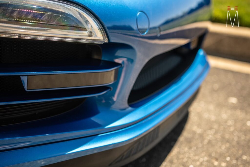 A close up of the front of a blue car