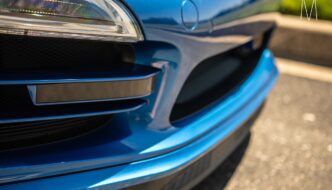 A close up of the front of a blue car